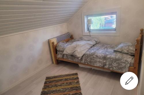 a small bedroom with a bed and a window at 2 bed room Quite and central house in Orebro in Örebro