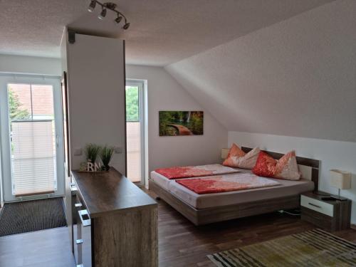 a bedroom with a bed and a desk in it at Ferienwohnung Braun in Echlishausen