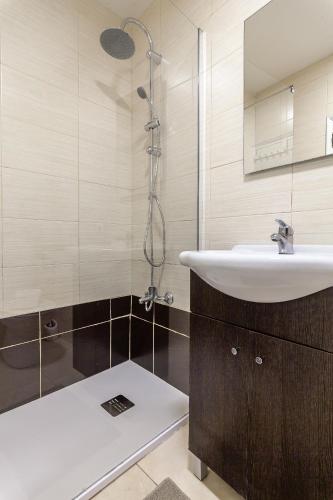 a bathroom with a sink and a shower at Arrochela by Home Sweet Home Aveiro in Aveiro