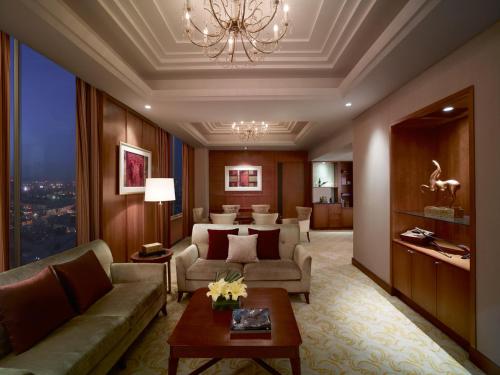 a living room with a couch and a table at Shangri-La Huhhot in Hohhot