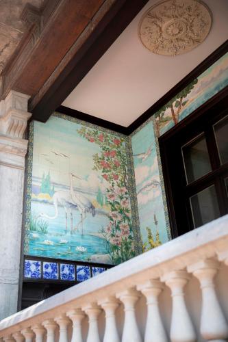 a painting on the wall of a house with a balcony at MOLO roof - stylish penthouse with marina view Blankenberge within walking distance from the sea - 15 km from Bruges in Blankenberge