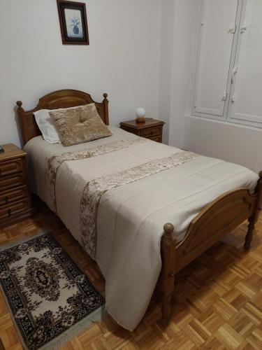 a bedroom with a bed and two night stands at Residencial Real - Antiga Rosas in Vila Real
