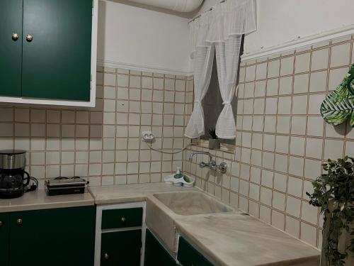 a small kitchen with a sink and a window at JR apartments in Athens