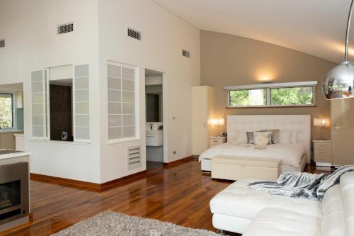 a bedroom with two beds and a living room at Silkwood Estate in Pemberton