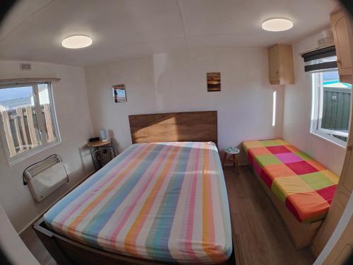 En eller flere senge i et værelse på Blauwe Lagune