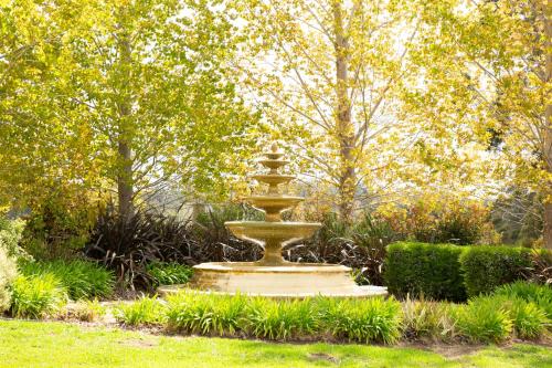 a fountain in the middle of a garden at Silkwood Estate in Pemberton