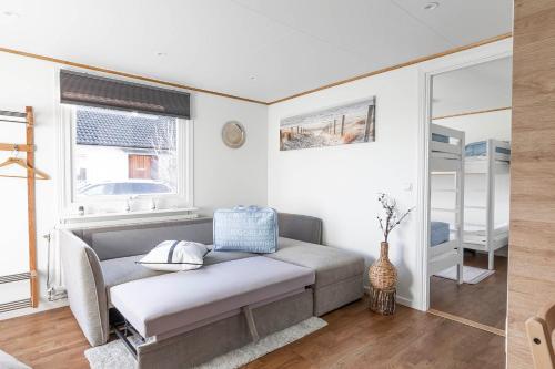 a living room with a couch and a window at Slottstuga in Borgholm