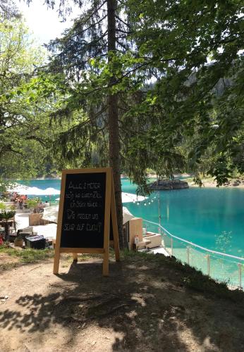 a sign in front of a body of water at Ferienwohnung Stenna SELVA direkt bei Bergbahnen Skipiste in Flims