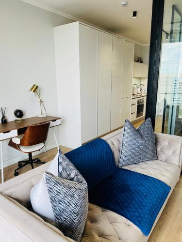 a couch with pillows on it in a living room at Ellipse Apartment in Midrand