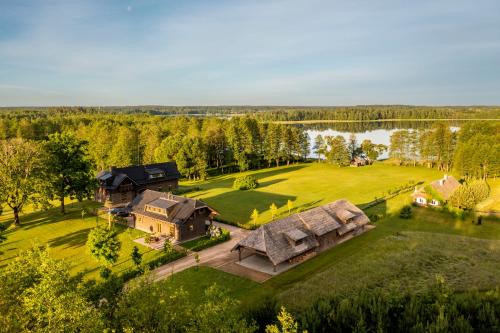 an aerial view of a large estate with a house and a lake at Kuliniai by Stirniai lake Moletai district in Kulintse