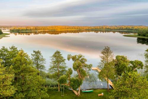 an aerial view of a lake with a house at Kuliniai by Stirniai lake Moletai district in Kulintse