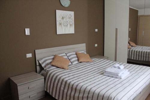 a bedroom with a bed and a mirror at La Maison di Gabriella e Alfredo in Edolo