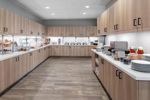 a large kitchen with wooden cabinets and white counter tops at Residence Inn by Marriott Big Sky/The Wilson Hotel in Big Sky