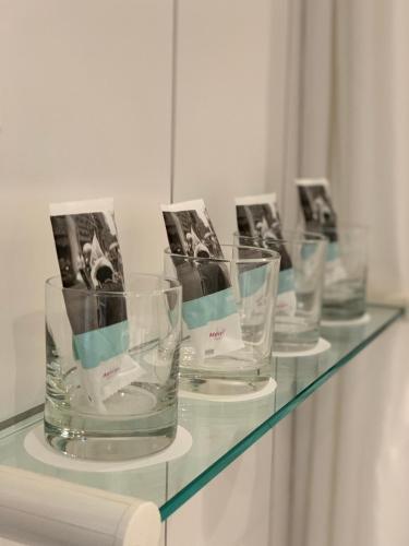 a glass counter with four empty glasses on it at Mercure Hotel Riesa Dresden Elbland in Riesa