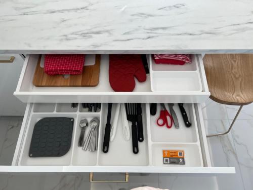 a drawer under a kitchen counter with utensils at Luxueux appartement - vue mer - piscine - free parking - Monaco in Cap d'Ail