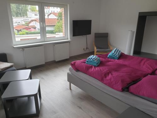 a bedroom with a large bed with purple sheets at DTS Appartements in Putbus