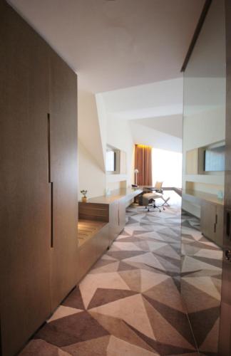 an office room with a hallway with a desk and a floor at Vivanta New Delhi, Dwarka in New Delhi