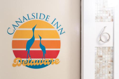a sign on a wall with the words availableamine furniture at Canalside Inn in Rehoboth Beach
