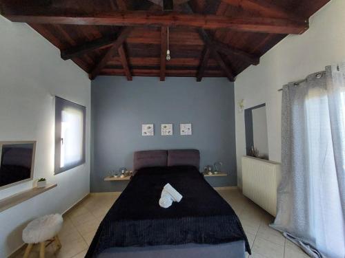 a bedroom with a large bed in a room at Dimitra's Villa in Evia, Greece in Loukísia