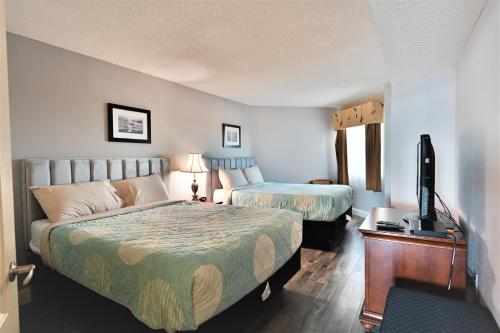 Cette chambre comprend 2 lits et une télévision à écran plat. dans l'établissement Amazing Ocean Views CB 20th Floor, à Myrtle Beach