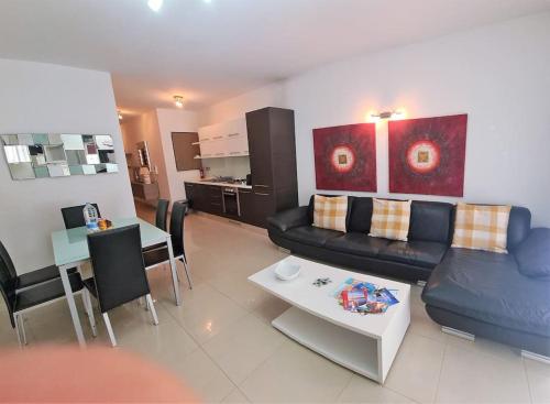 a living room with a couch and a table at Belmonte Heights, Block I, Apartment 19 in Sliema