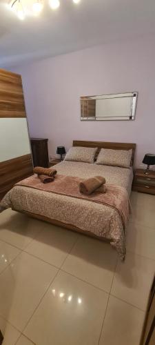 a bedroom with a bed with two towels on it at Belmonte Heights, Block I, Apartment 19 in Sliema