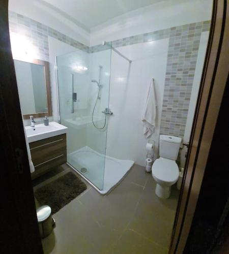 a bathroom with a shower and a toilet and a sink at Belmonte Heights, Block I, Apartment 19 in Sliema