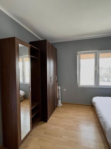 a bedroom with a bed and a closet and a window at Old Town Bar Apartments in Stari Bar