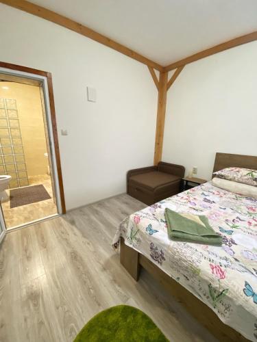 a bedroom with a bed and a bathroom with a window at Villa “Eleon” in Velyka Bihanʼ