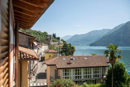a view of a town and a lake from a building at IseoLakeRental - Casa del Pescatore in Riva di Solto