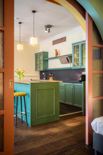 a kitchen with green cabinets and a green island at Hotel Nieuw Antiek in Helden