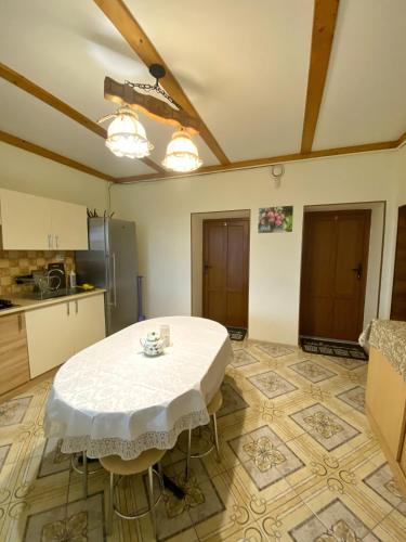 a kitchen with a white table in a room at Villa “Eleon” in Velyka Bihanʼ