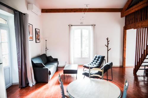 a living room with a couch and a table at Domaine des Églantiers in Cardet