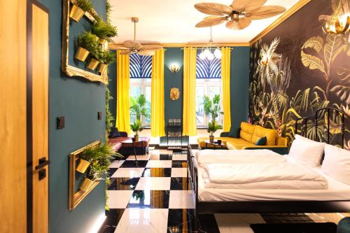 a living room with two beds and a couch at Jungle Apartments Podwale in Wrocław