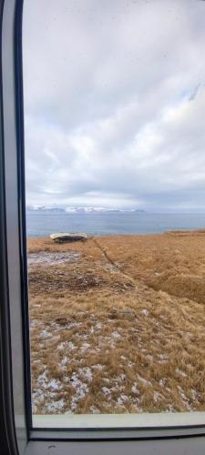 a view of a field from a train window at Happy-Cove Guesthouse - by the sea in Bakkafjörður