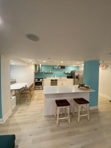 a large kitchen with a white counter and chairs at Canalside Inn in Rehoboth Beach