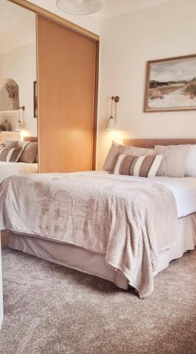 a bedroom with a large bed and a mirror at Churchview in Townhill