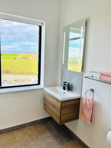 a bathroom with a sink and a window at Greene Acres - Room Only in Doolin