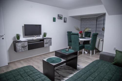 a living room with a couch and a table at Happy in Pirot