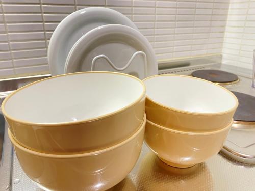 three bowls sitting on a counter in a kitchen at Nakajima Park stay AMS tower 32F Panoramic view of Sapporo city in Sapporo