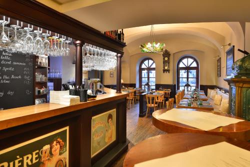 a restaurant with a bar and some tables and chairs at Hotel Morris Premium Collection in Česká Lípa