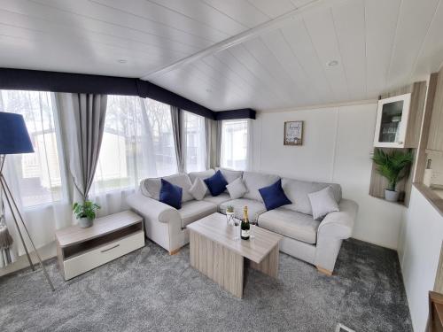 a living room with a couch and a table at Seven Sunsets, Padstow in Padstow
