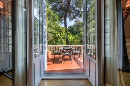 an open door to a porch with a table and chairs at Santo Mauro, a Luxury Collection Hotel, Madrid in Madrid