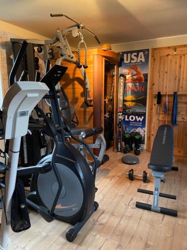 a gym with several exercise equipment in a room at Privathaus Wehle in Kurort Gohrisch