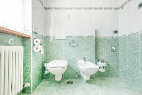 a bathroom with a toilet and a sink at CROSINA HOLIDAY - Residence Toli in Ledro