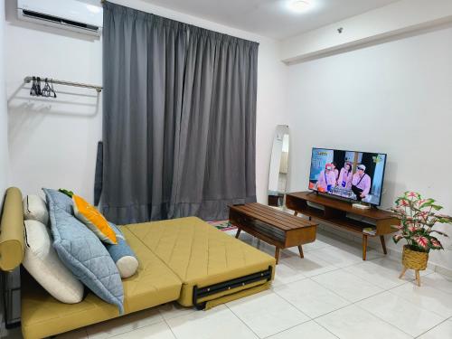 a living room with a couch and a flat screen tv at The Sun 1 or 3BR Bayan Lepas 4 to 10 pax WL in Bayan Lepas