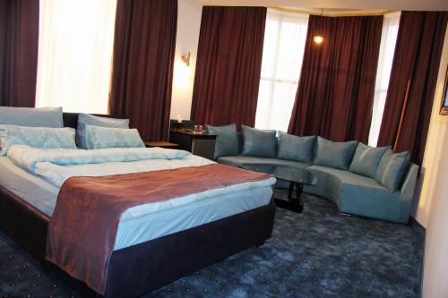 a hotel room with a bed and a couch at Nice Hotel Yerevan in Yerevan