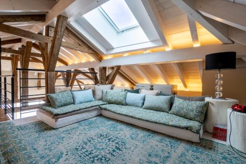 a living room with a couch and a skylight at La Ferme du Lanchet in Lamoura
