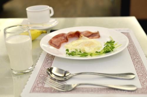 a plate of food with meat and greens on a table at Hi-YES HOTEL TAOYUAN in Zhongli
