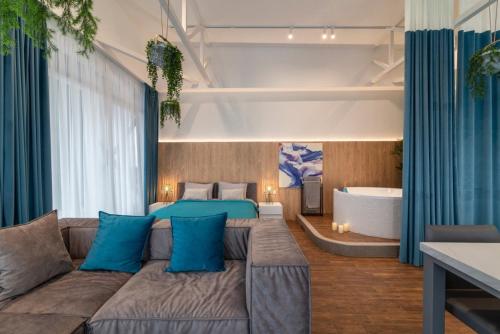 a living room with a couch and a bed at Stylish 1 bedroom studio near Most City in Dnipro